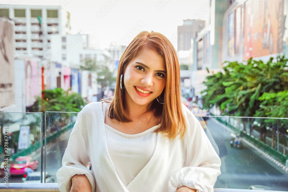 Fototapeta premium Close-up beautiful woman smile portrait at walking street in the city.