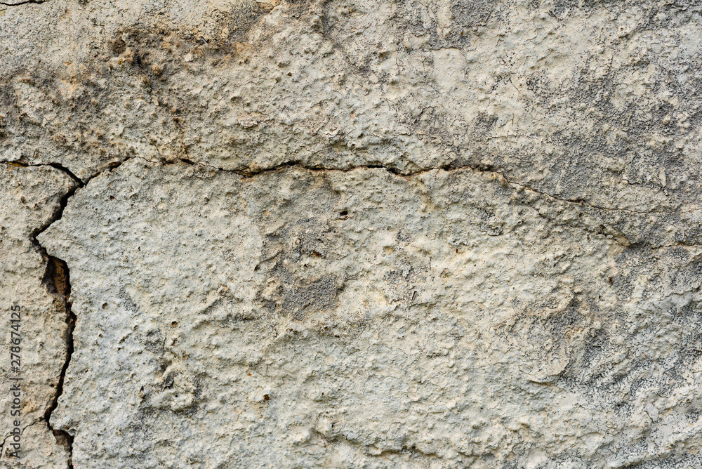 Texture of a concrete wall with cracks and scratches which can be used as a background Texture of a concrete wall with cracks and scratches which can be used as a background