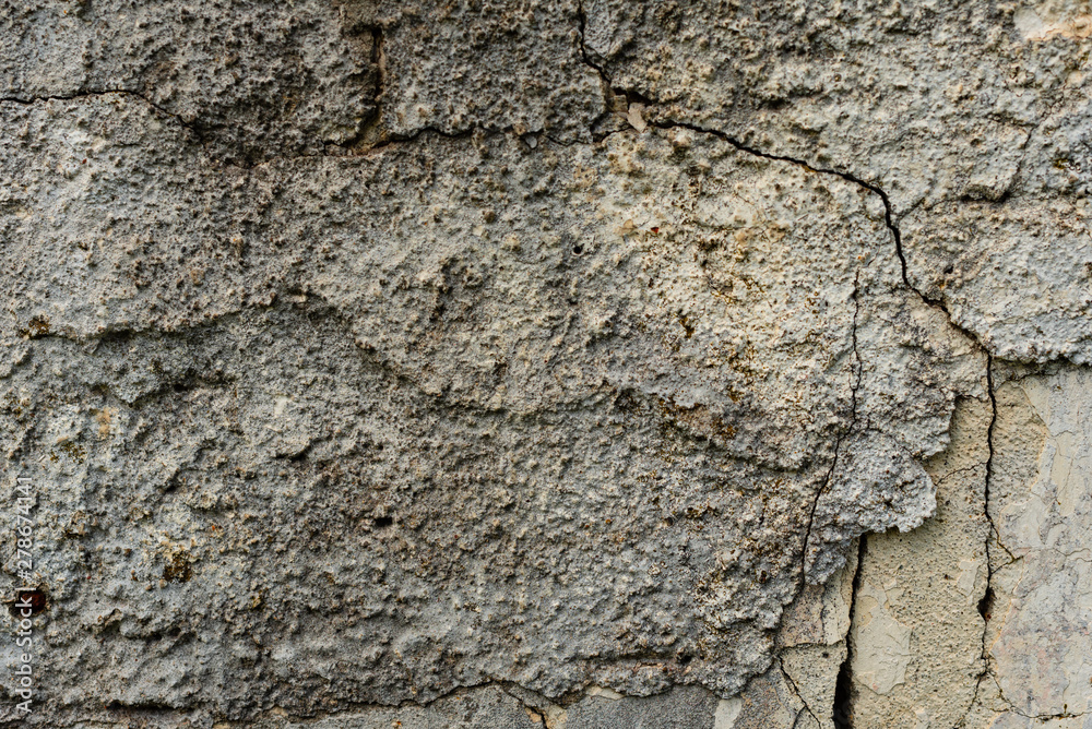 Texture of a concrete wall with cracks and scratches which can be used as a background Texture of a concrete wall with cracks and scratches which can be used as a background