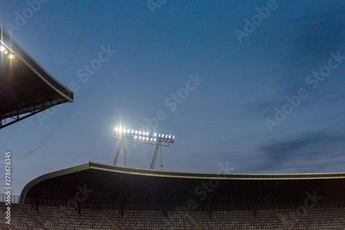 Fototapeta Naklejka Na Ścianę i Meble -  Stadium lights against blue sky