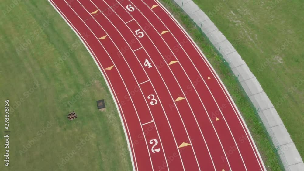 Aerial view of high school track field with the lane numbers for starting long-distance running events