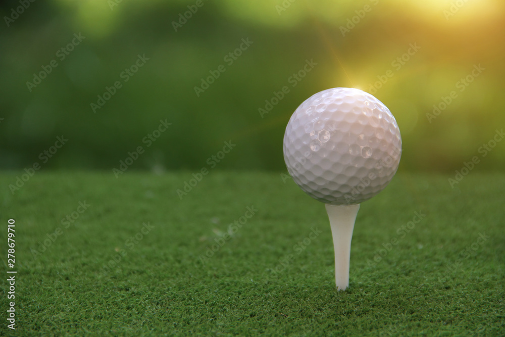 Golf ball on tee in beautiful golf course at sunset background. Golf ball on tee in beautiful golf course at sunset background.