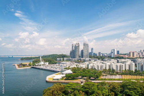 Aerial view of modern Asian cityscape with skyscrapers and tropical plants © Olga K