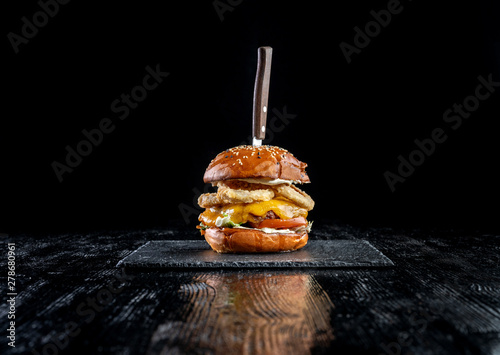 Homemade double cheese burger with onion ring.