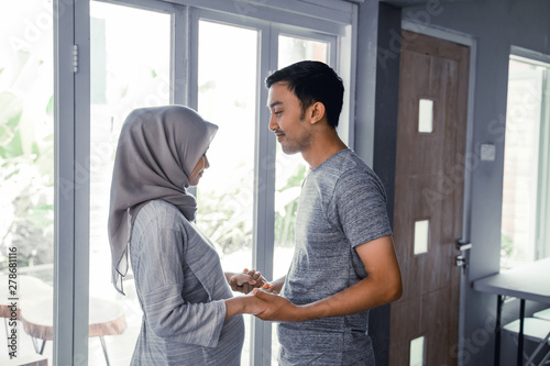 romantic muslim husband and wife face to face each other at home