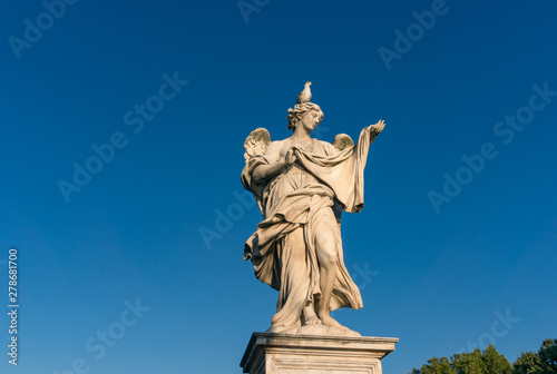 Statue of angel with bird sitting on its head