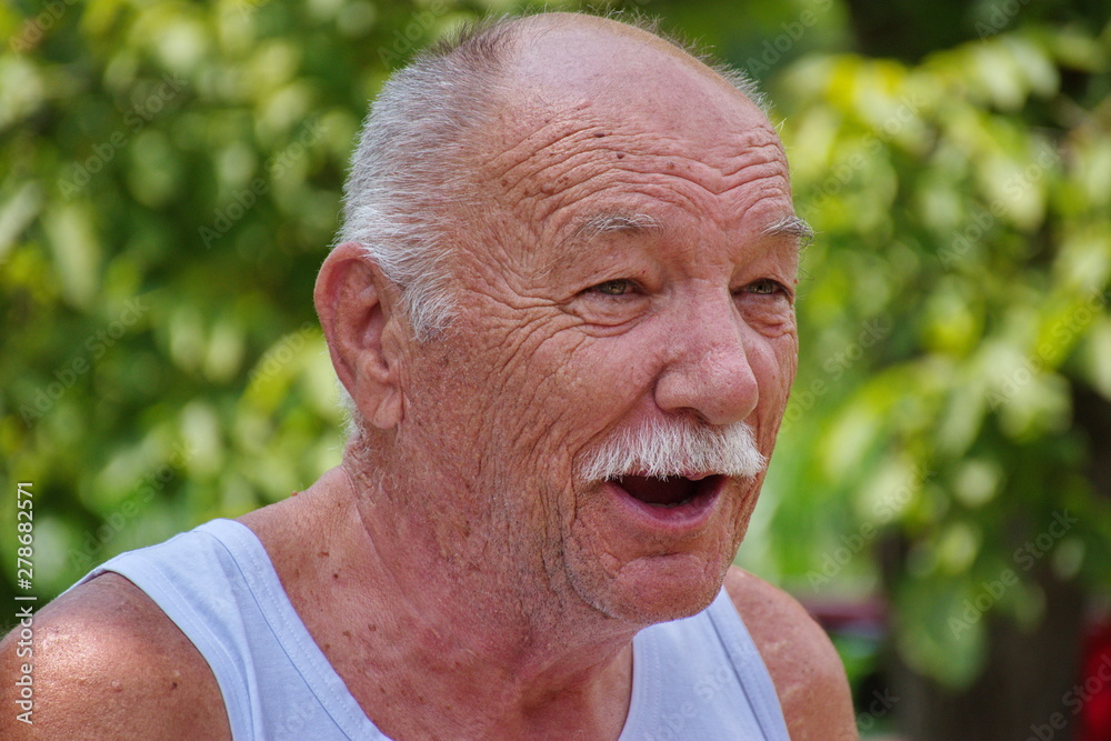 Portrait of the senior man in the garden Portrait of the senior man in the garden