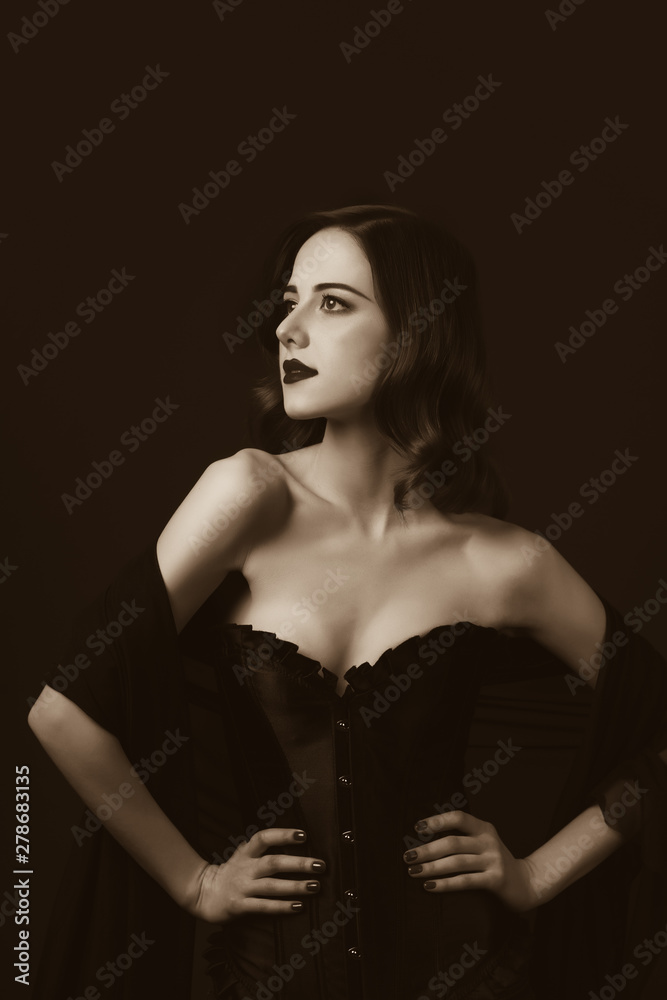 Young redhead woman in black corset Young redhead woman in black corset