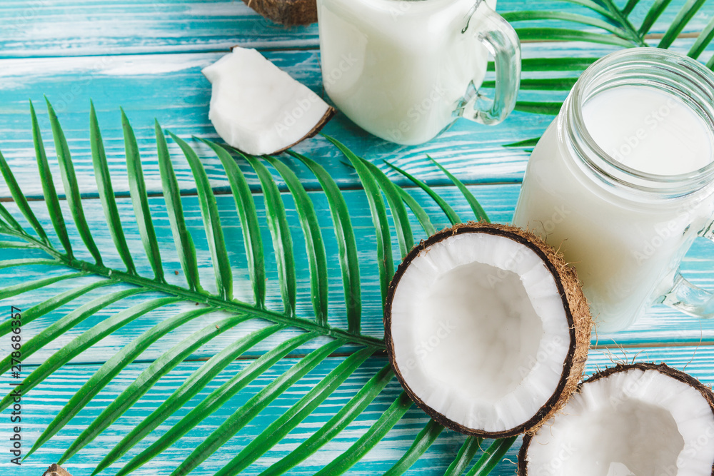 Creative layout made of coconuts and tropical leaves. Food concept Creative layout made of coconuts and tropical leaves. Food concept