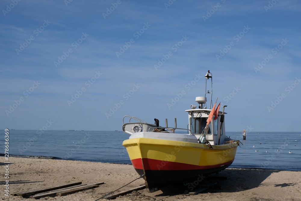 Wooden fishing boat on the beach of Baltic Sea in Sopot/Poland in sunny summer day. Wooden fishing boat on the beach of Baltic Sea in Sopot/Poland in sunny summer day.