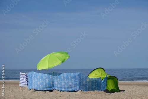 Windbreaks and sun umbrella on the beach - on polish beaches of Baltic Sea you can see them very often. © Iwona