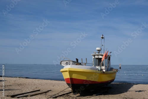 Fototapeta Naklejka Na Ścianę i Meble -  Wooden fishing boat on the beach of Baltic Sea in Sopot/Poland in sunny summer day. 