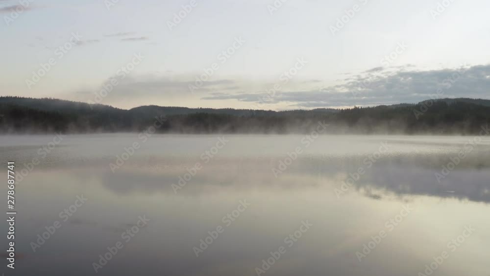 4K anamorphic video of fog mist drifting over beautiful and calm lake during sunrise golden hour in Maridalen in Oslo, Norway. 4K anamorphic video of fog mist drifting over beautiful and calm lake during sunrise golden hour in Maridalen in Oslo, Norway.