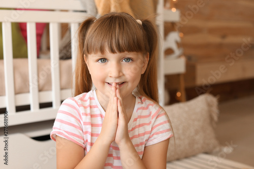 Little girl praying at home