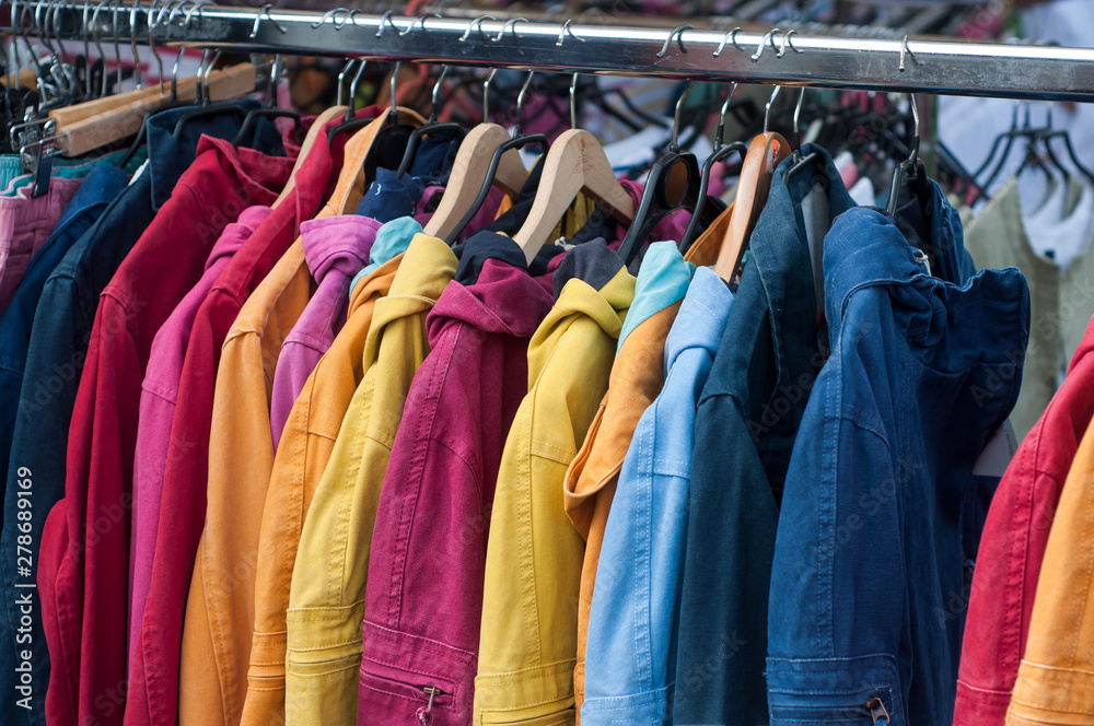 Obraz premium closeup of fishing vests collection on hanger at the market