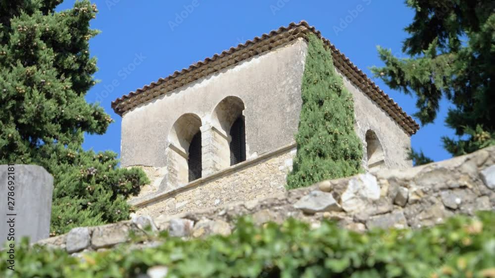 Steeple Of A Provencal Church Under A Sunny Sky in slowmotion in summer Steeple Of A Provencal Church Under A Sunny Sky in slowmotion in summer