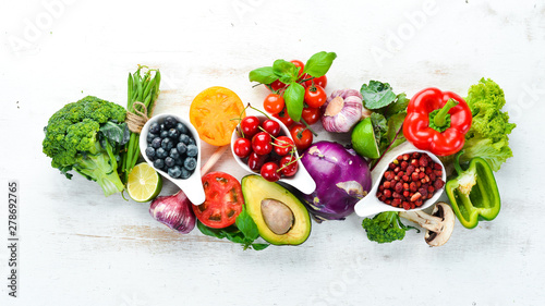 Fototapeta Naklejka Na Ścianę i Meble -  Fresh fruits and vegetables on a white wooden background. Top view. Free space for your text.
