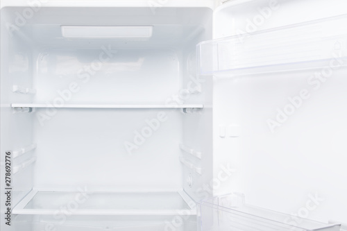 close-up, empty shelves and doors, white refrigerator