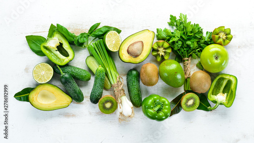 Fototapeta Naklejka Na Ścianę i Meble -  Fresh organic green fruits and vegetables. Avocado, kiwi, onion, lime, parsley. Organic food. Rustic style. Top view. Free space for text.