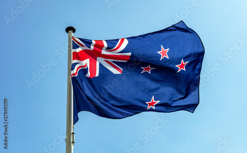 Canvas Print New Zealand flag waving against clear blue sky