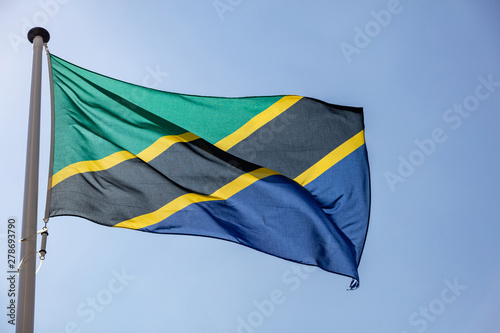 Tanzanian flag waving against clear blue sky