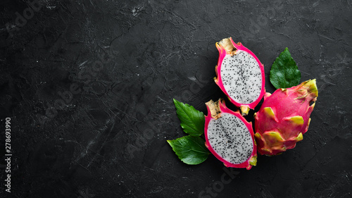 Fresh Pytahya on a black background. Dragon Fruit. Tropical Fruits. Top view. Free space for text.