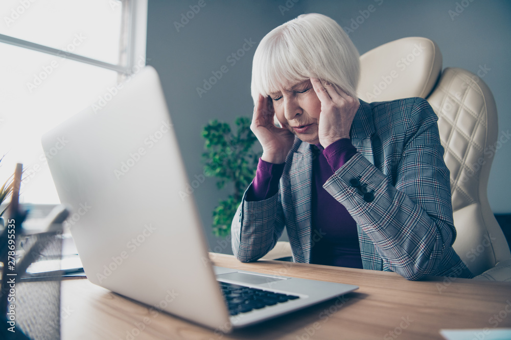 Close up photo of aged business lady unwell hold hand temples overworked need rest day off sit office chair wear costume suit jacket Close up photo of aged business lady unwell hold hand temples overworked need rest day off sit office chair wear costume suit jacket