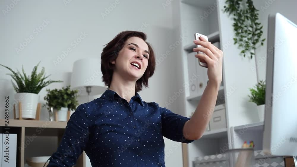 Young blogger talks to her followers using her smartphone. She shows the color palletes to them Young blogger talks to her followers using her smartphone. She shows the color palletes to them