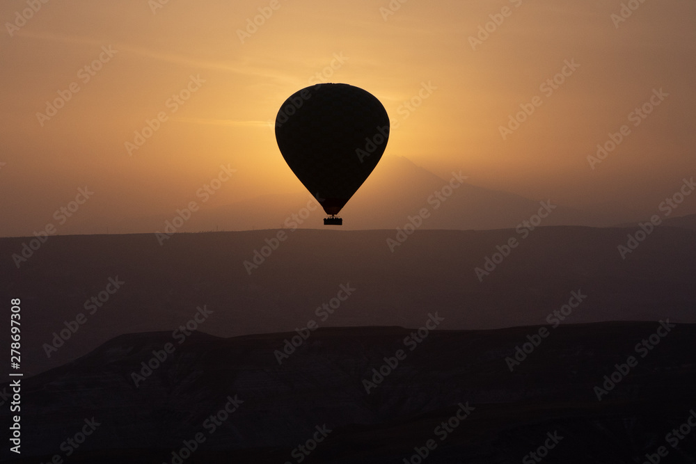 Hot air balloons flying over spectacular Cappadocia on sunset. Hot air balloons flying over spectacular Cappadocia on sunset.