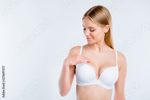 Portrait of nice dreamy attractive charming sweet perfect shape fit form curvy line girl touching breast plastic surgery salon procedure isolated over white light gray background