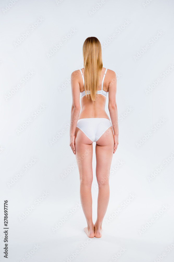 Vertical full length body size rear back behind view of nice attractive skinny  thin sportive girl perfect figure shape form line standing straight long  legs isolated over light gray background Stock Photo