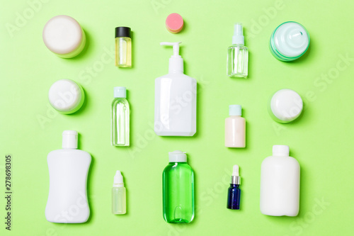 Group of plastic bodycare bottle Flat lay composition with cosmetic products on green background empty space for you design. Set of White Cosmetic containers, top view with copy space