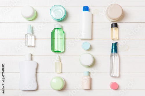 Group of plastic bodycare bottle Flat lay composition with cosmetic products on wooden background empty space for you design. Set of White Cosmetic containers, top view with copy space