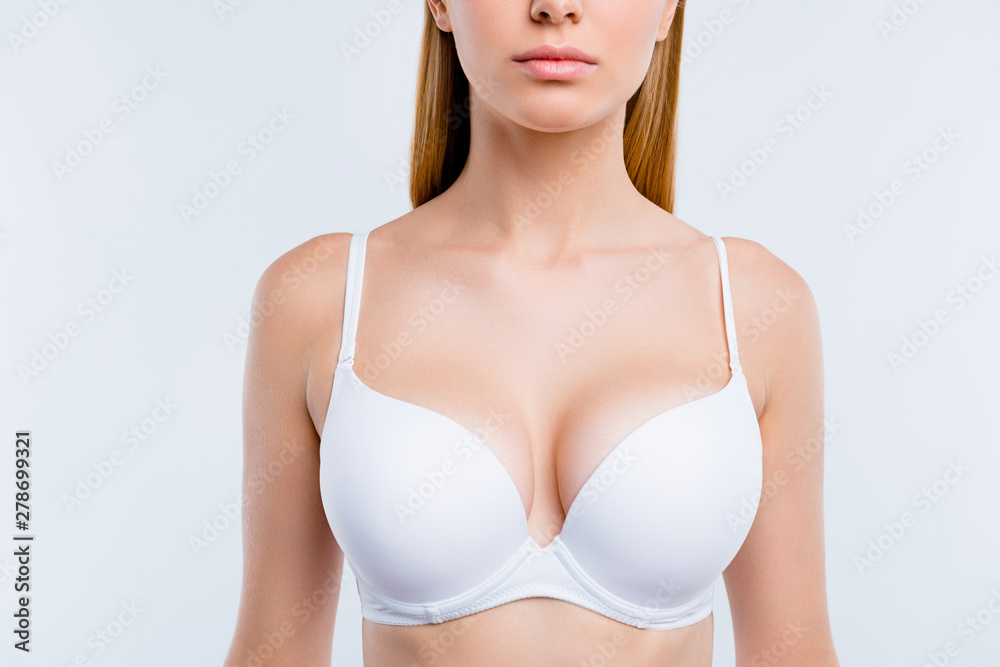 Healthy lifestyle concept. Cropped close-up portrait of nice calm lovely  attractive adorable blonde girl chest wearing bra isolated over light gray  background Stock Photo