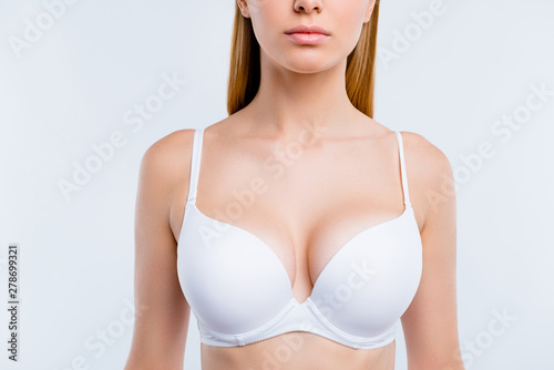 Healthy lifestyle concept. Cropped close-up portrait of nice calm lovely attractive adorable blonde girl chest wearing bra isolated over light gray background