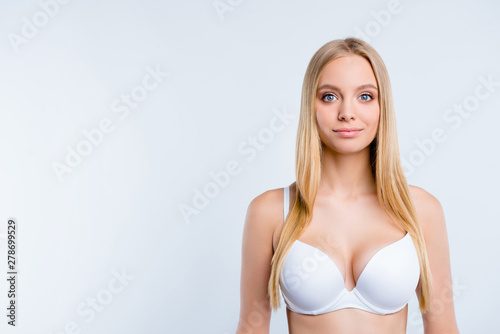 Portrait of nice sweet lovely tender winsome delicate attractive charming blonde girl wearing bra copy space isolated over light gray background photo