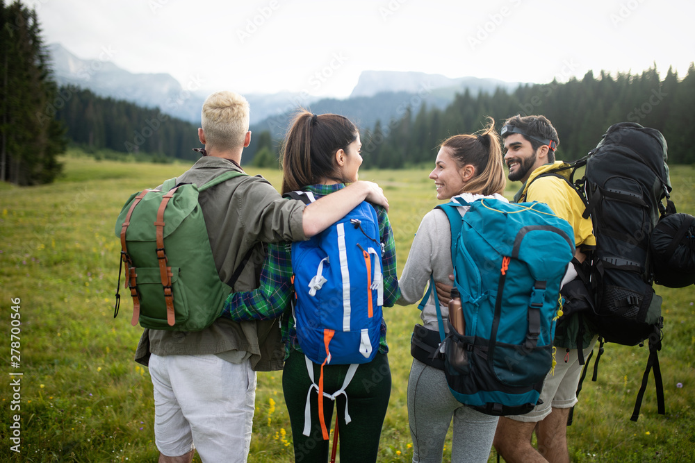 Group of young friends hiking in countryside. Multiracial young people on country walk. Group of young friends hiking in countryside. Multiracial young people on country walk.