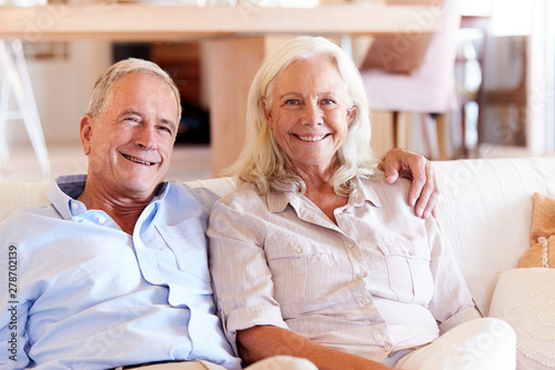 Senior white couple relaxing at home  smiling to camera  front view  close up