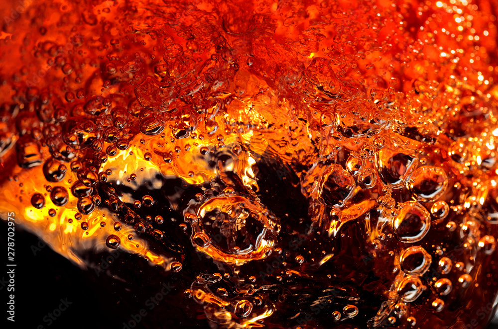 Alcoholic drink on a dark background, abstract splashing. Alcoholic drink on a dark background, abstract splashing.