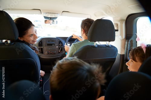 Young white family making a trip in their car, close up, back view car interior shot