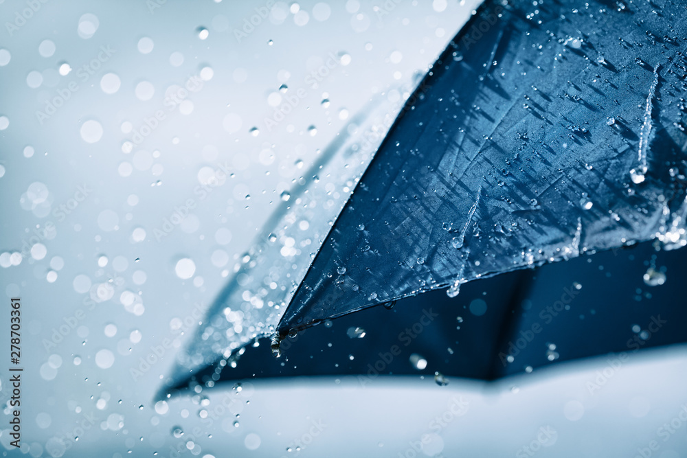 Blue umbrella under heavy rain against cloudy sky background. Rainy weather concept. - obrazy, fototapety, plakaty 