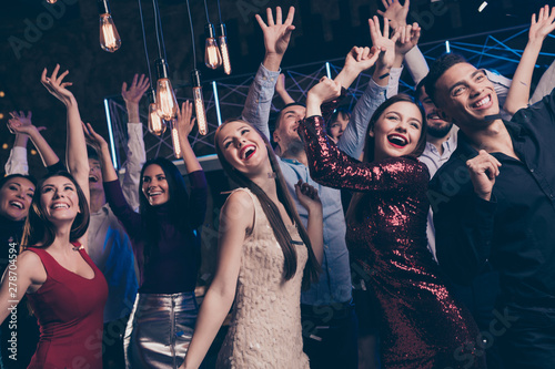 Close up photo of cute charming buddies people funny funky raise hands dance floor discotheque indoors free time cheerful