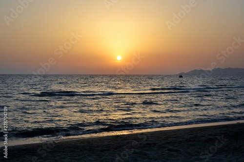 Sunset over Adriatic Sea. View from Golem / Durres, Albania. Beautiful sunset with Durres town silhouette in the distance