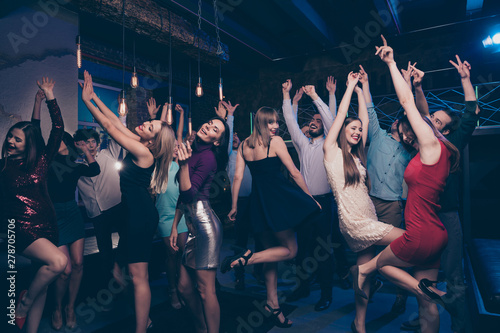Nice-looking gorgeous attractive glamorous slim fit thin graceful cheerful positive stylish girls and guys having fun festive festal social life lifestyle in fashionable luxury place nightclub indoors