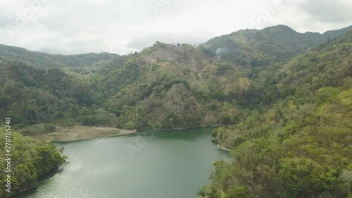 Wallpaper Mural Aerial view bushy green hills and tropical river landscape. Beautiful landscape from above flying drone tropical highlands and lake. Torontodigital.ca