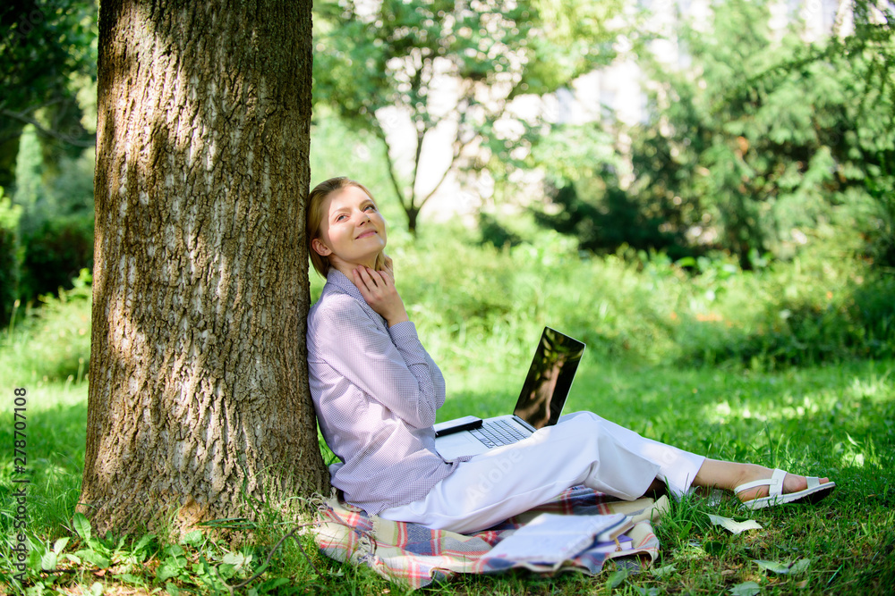 Education technology and internet concept. Girl work with laptop in park sit on grass. Natural environment office. Work outdoors benefits. Woman with laptop work outdoors lean tree. Minute for relax Education technology and internet concept. Girl work with laptop in park sit on grass. Natural environment office. Work outdoors benefits. Woman with laptop work outdoors lean tree. Minute for relax