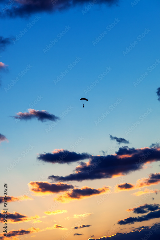 skydiver against the sunset sky