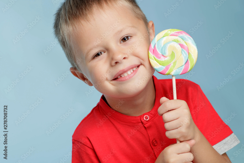 A child with candy. A little boy is holding candy in his hands. 