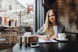 Young businesswoman working in a cafe