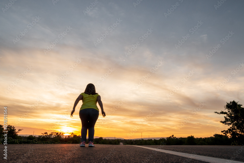 Happy woman jump At the time of the sun set Concept of vacation and travel